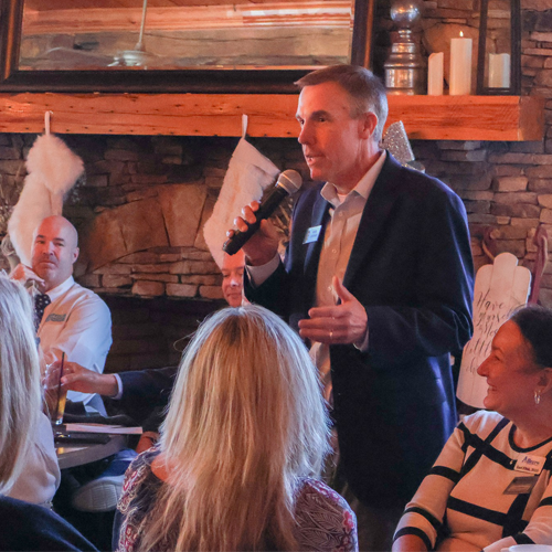 Man talking from microphone at business meeting