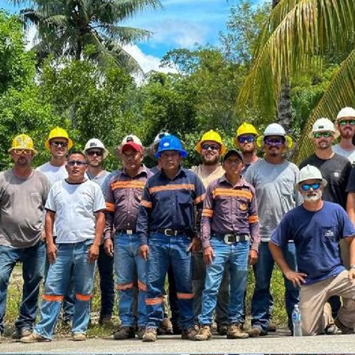 A group of linemen with residents of Guatemala