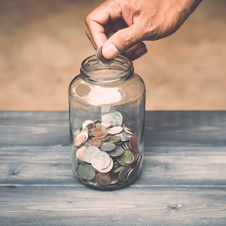 dropping coins into a jar