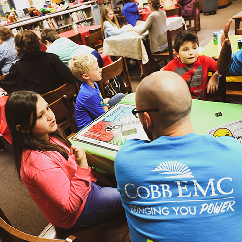 Cobb EMC employee with students