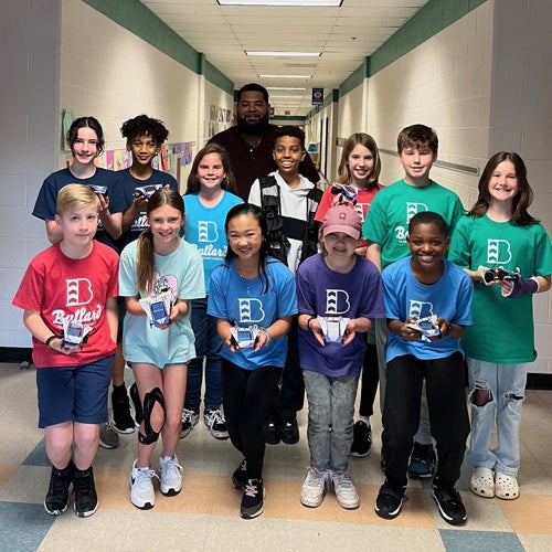 Children holding solar cars