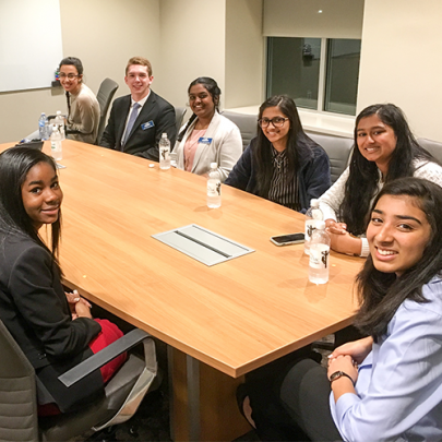 students at conference table